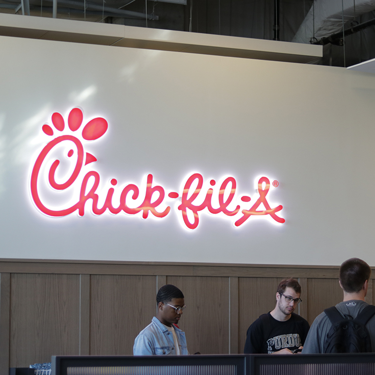 Chick-fil-a sign hanging in the food court area.